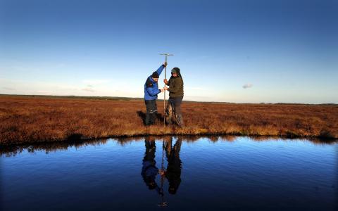 Blawhorn Moss NNR - staff measuring peat depth.© Lorne Gill/NatureScot