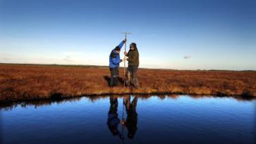 Blawhorn Moss NNR - staff measuring peat depth.© Lorne Gill/NatureScot